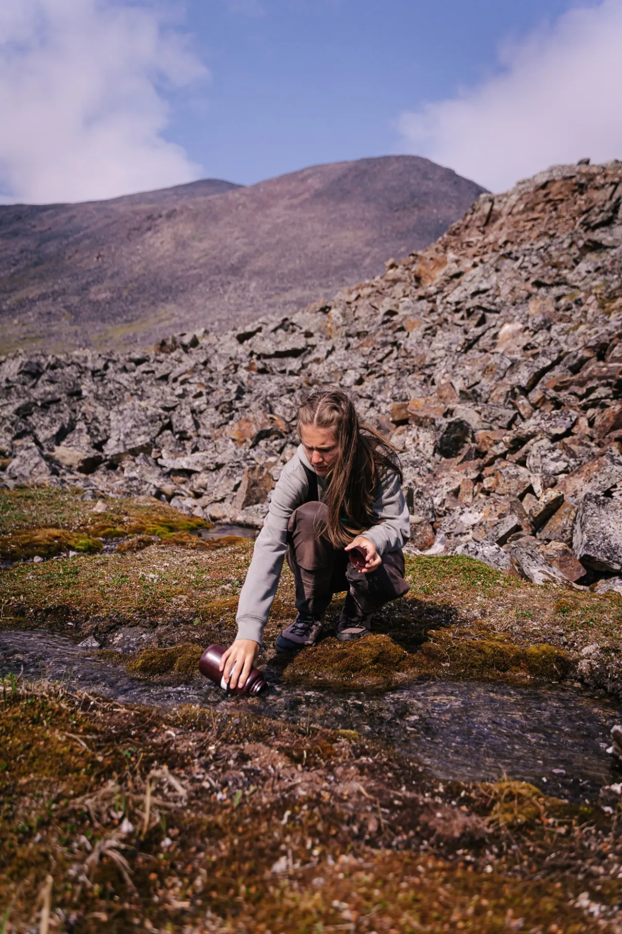 Michigan State University graduate student, Amelia Grose, collects soil water samples in the Brooks Range, North Slope, AK, Credit: Jansen Nipko