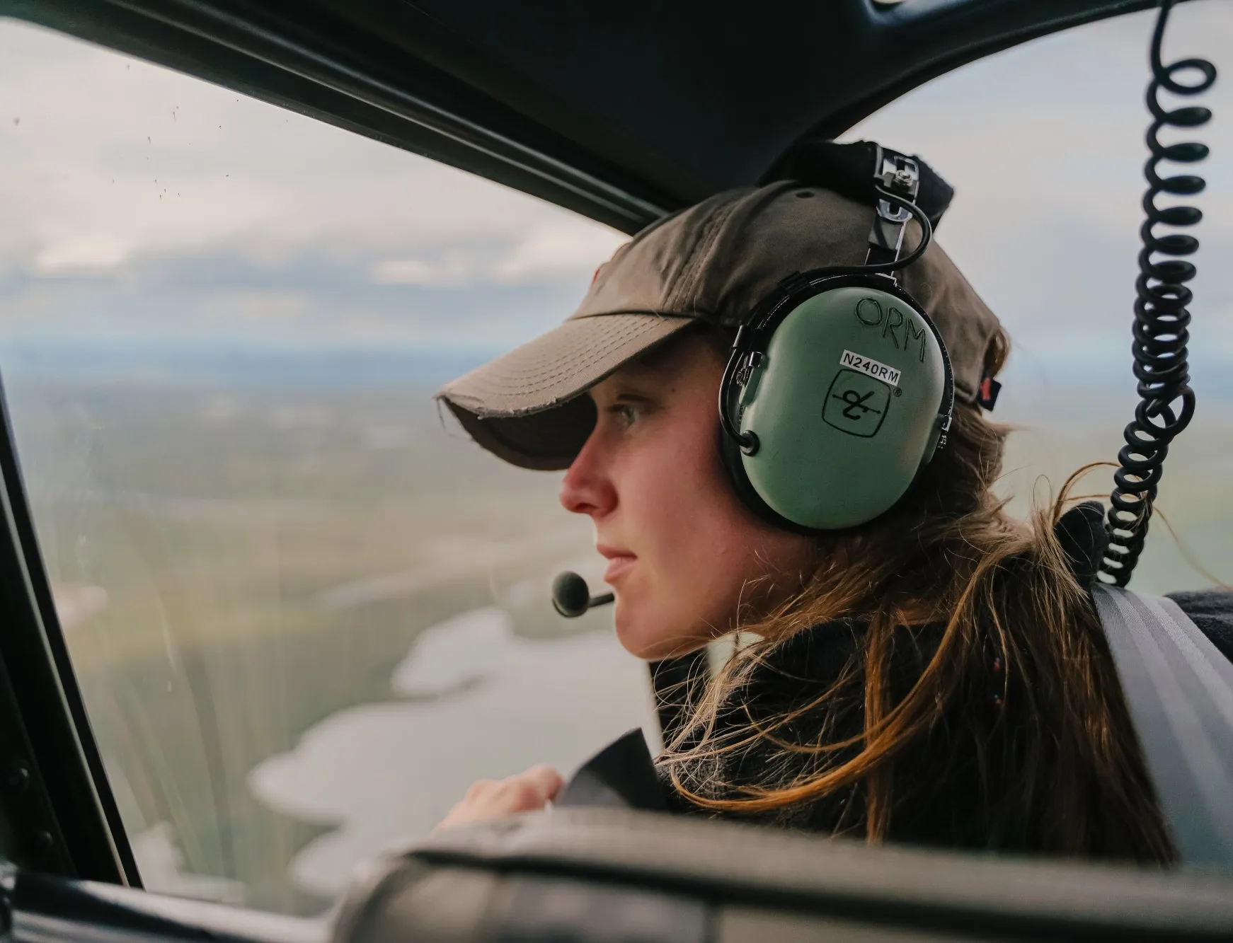 Abby Rec, a graduate student from University of Vermont, gazes over the Brooks Range in the North Slope of Alaska as she flies to some of her sample sites, Abby Rec, a graduate student from University of Vermont, gazes over the Brooks Range in the North Slope of Alaska as she flies to some of her sample sites, Credit: Jansen Nipko